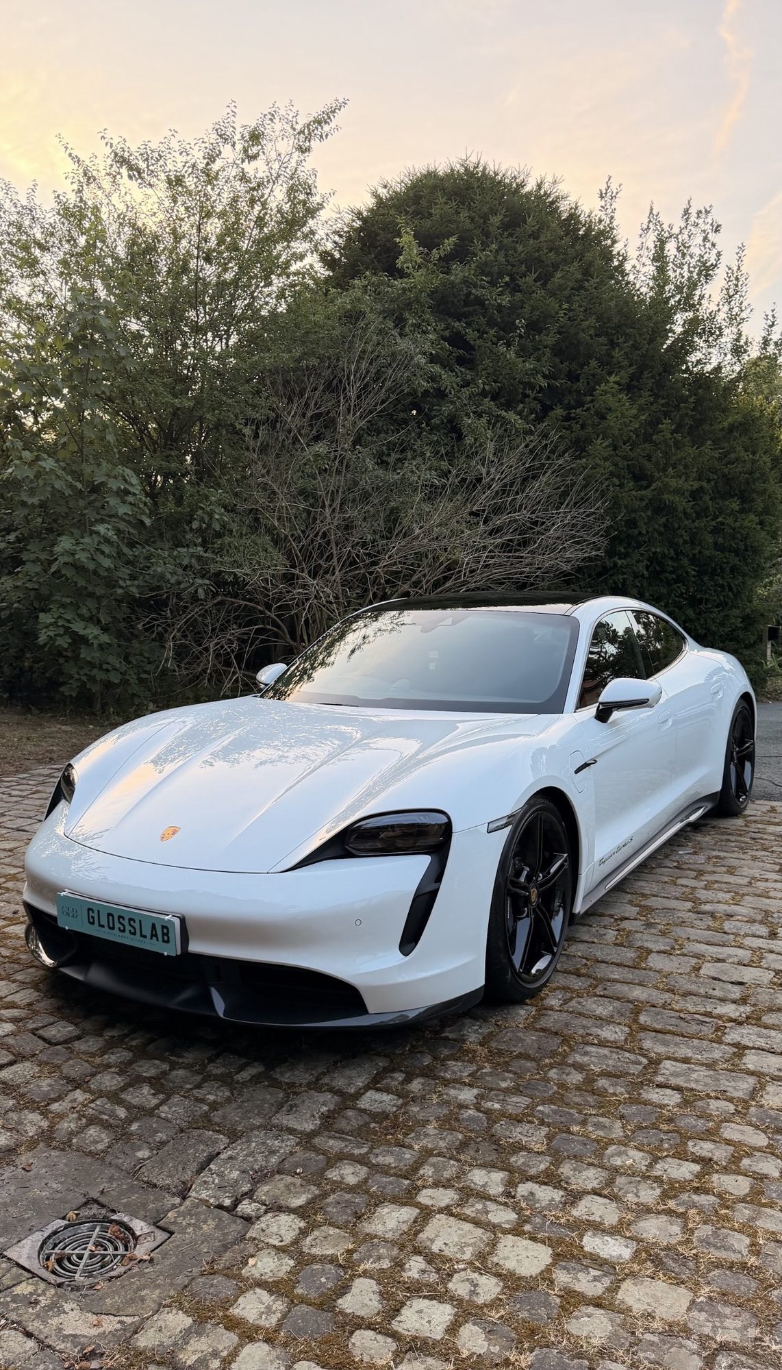 Freshly detailed Porsche Taycan at sunset